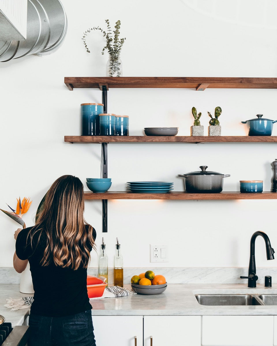 Girl cooking, wooden shelves